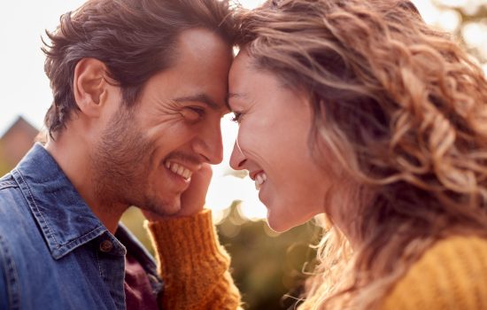 portrait,of,happy,loving,couple,head,to,head,outdoors
